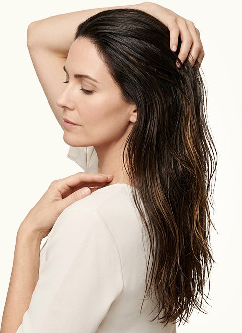 Cold-pressed castor oil worked through the mid-lengths and ends of long hair