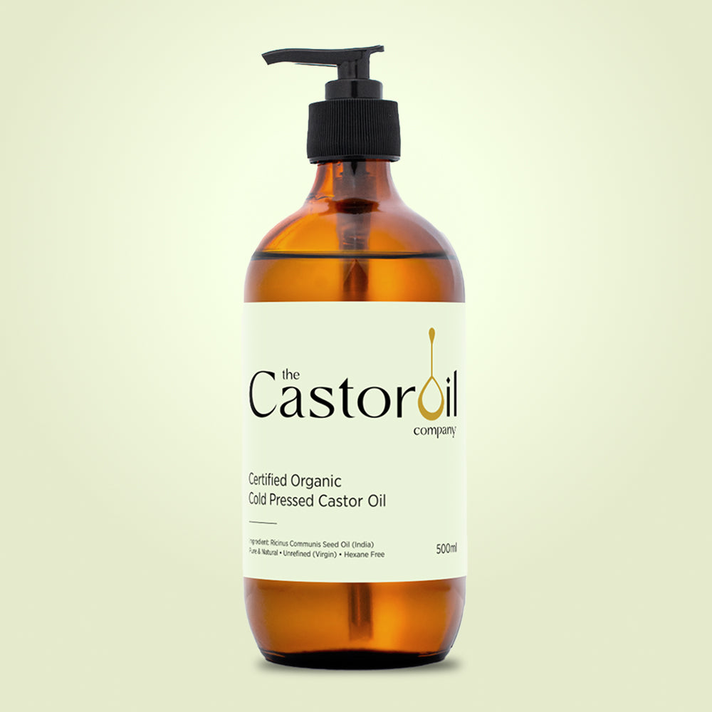 Certified organic cold-pressed castor oil in a 500ml amber glass bottle with pump dispenser